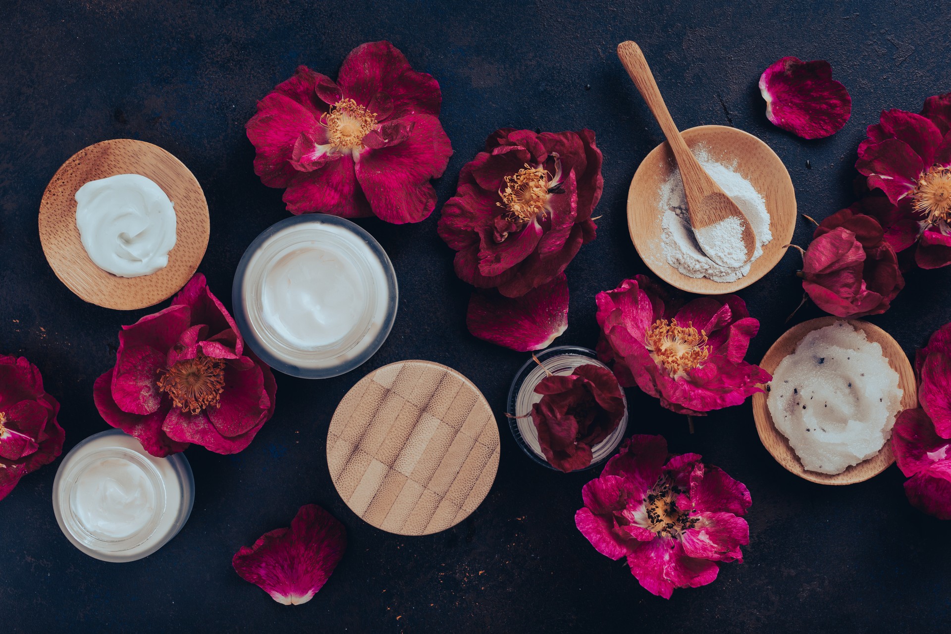 skincare products and dog rose flowers. natural cosmetics for home spa treatment