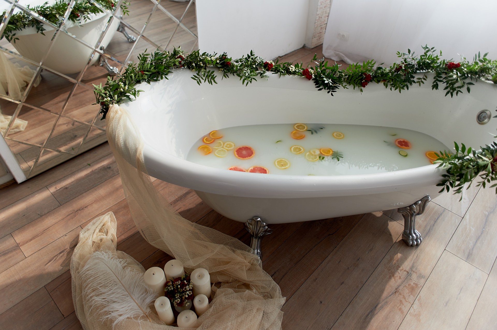 Elegant roll-top bath and decorated with flowers. In the water swim citrus.The atmosphere of relaxation, relaxation