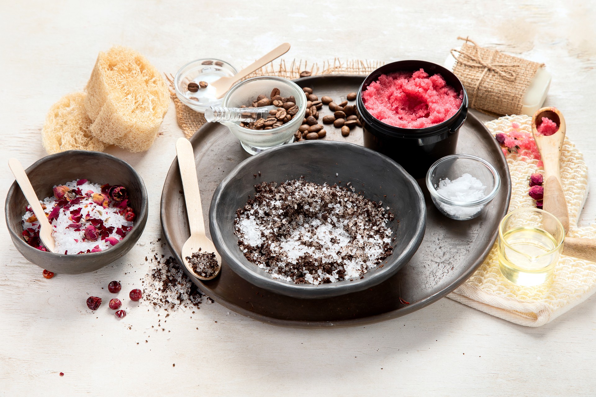 A woman's hand applies a natural coffee scrub. Skin care cosmetics. Beauty concept