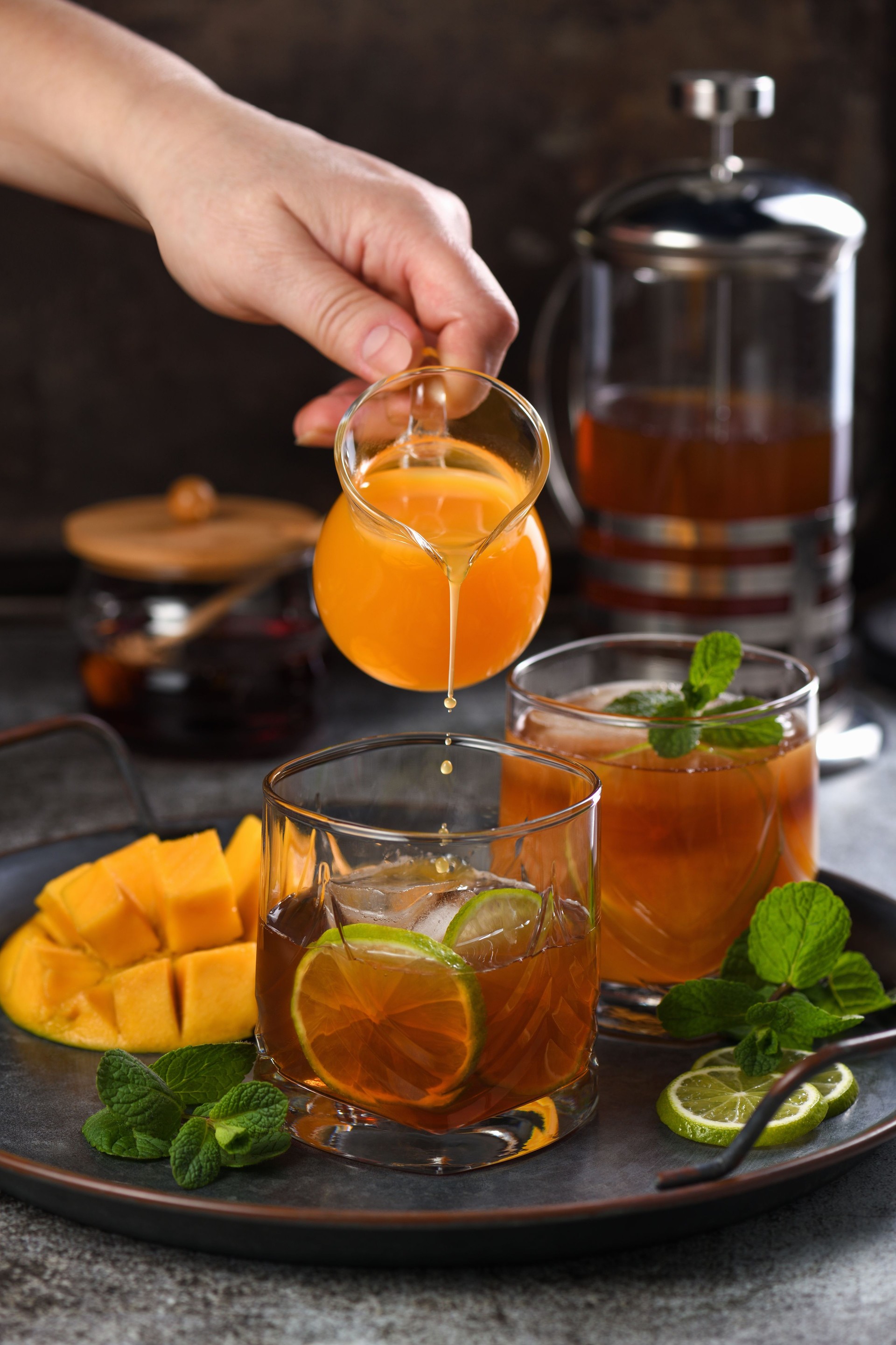 Mango iced tea with lime and mint. Refreshing organic soft drink
