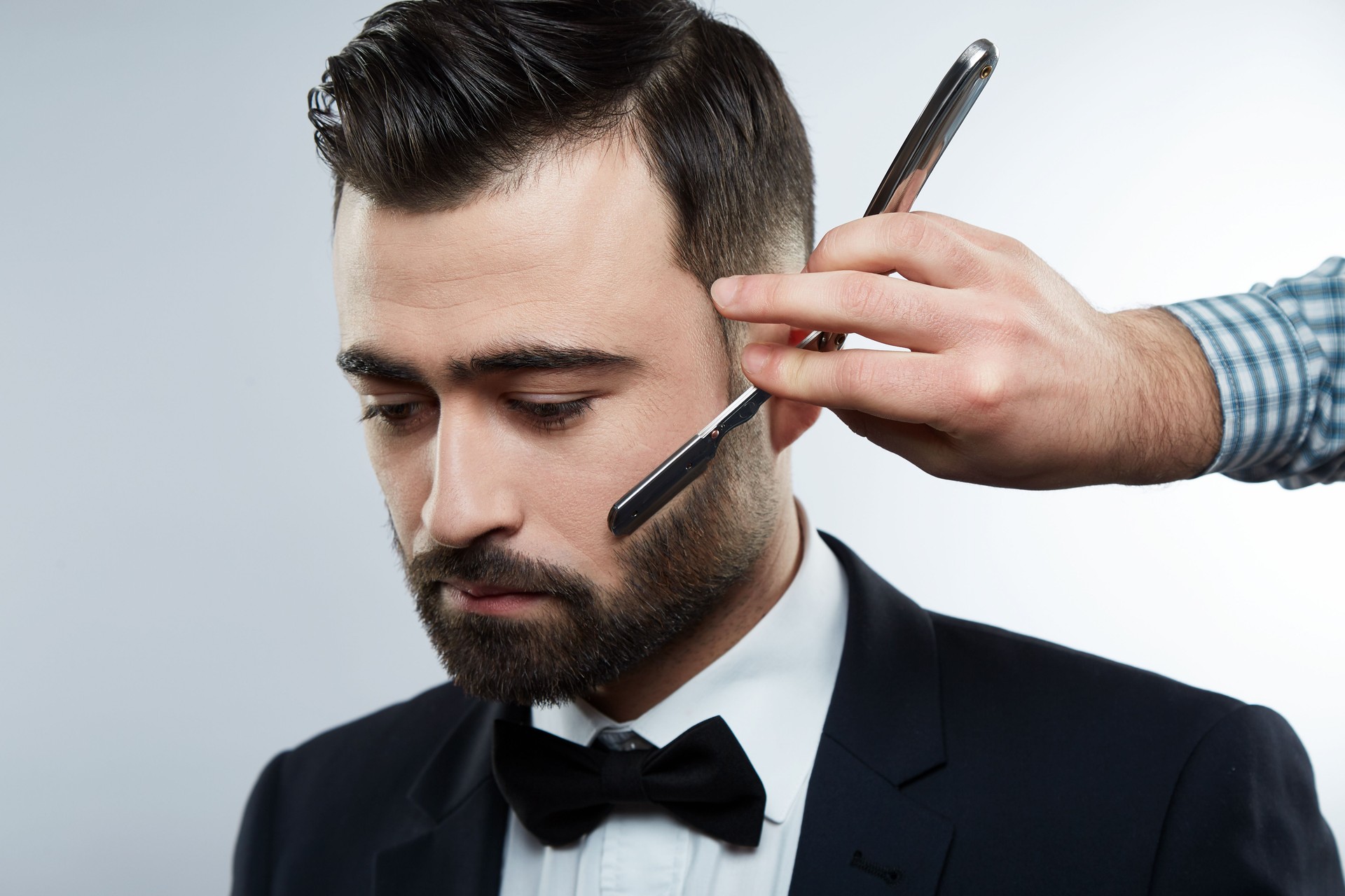 Man's hands making a beard