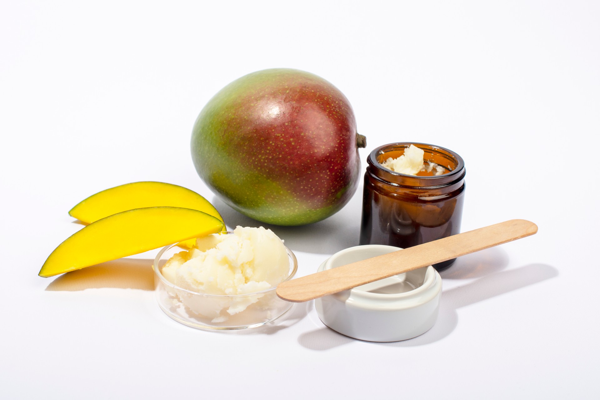 Mango butter and fresh mango fruit. Organic cosmetic, skin care, spa concept.