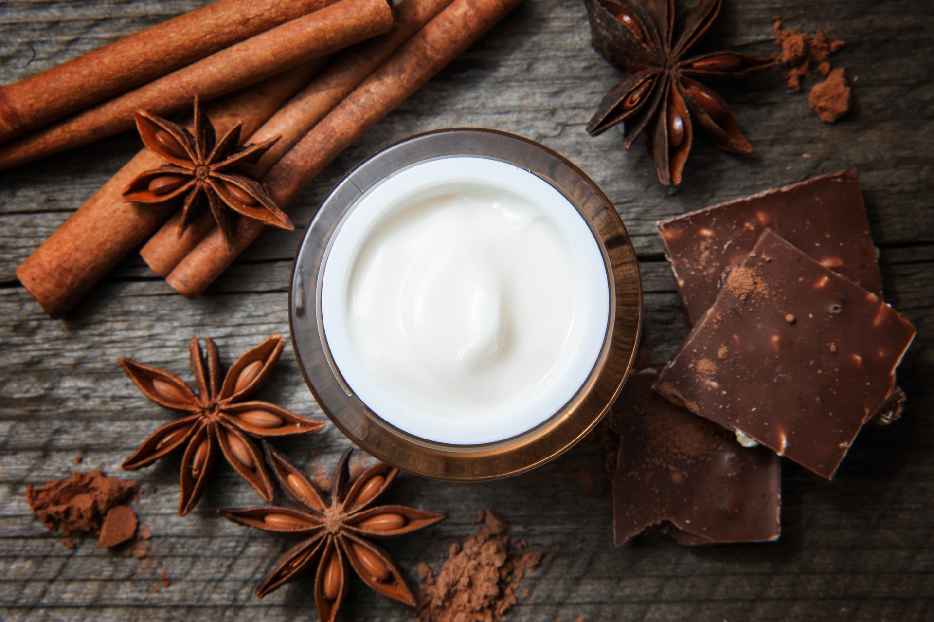 cinnamon purrrr balance body butter skin treatment. Cosmetic jar with lotion, cocoa, anise, cinnamon sticks.